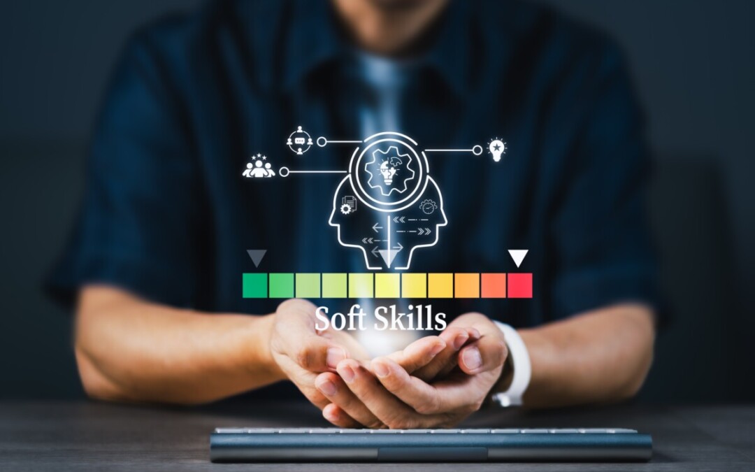 L’image montre un individu assis à un bureau, les mains ouvertes comme pour soutenir ou présenter quelque chose. Au-dessus de ses paumes, un graphique lumineux en réalité augmentée symbolise le concept de « Soft Skills ». On y voit deux profils humains stylisés en surimpression, reliés à des icônes représentant la communication, la créativité, l’intelligence émotionnelle, la collaboration et la résolution de problèmes. En dessous, une échelle de couleur allant du vert au rouge visualise le niveau ou l’intensité des compétences comportementales. Cette illustration évoque l'importance stratégique du développement des compétences humaines – en particulier chez les managers – pour la gestion proactive du conflit en entreprise. Elle souligne visuellement que les soft skills ne sont pas accessoires, mais bien au cœur de la capacité des leaders à détecter, désamorcer et transformer les tensions au travail.